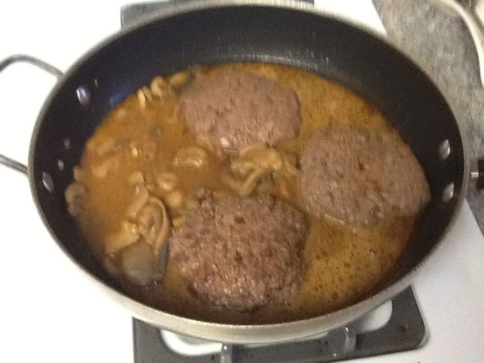 Pour in the gravy mix into the pan over each patty.