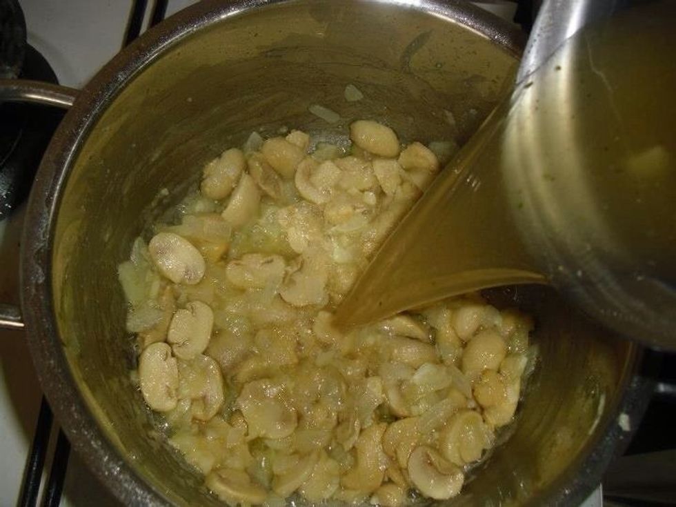 Pour in the hot chicken stock and bring to the boil.