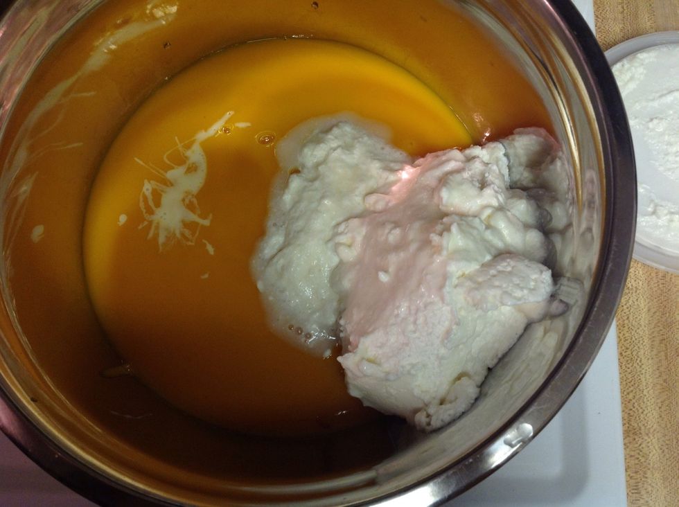 Pour in the mango pulp into a large mixing bowl, add sweetened condensed milk and whipped topping to it.