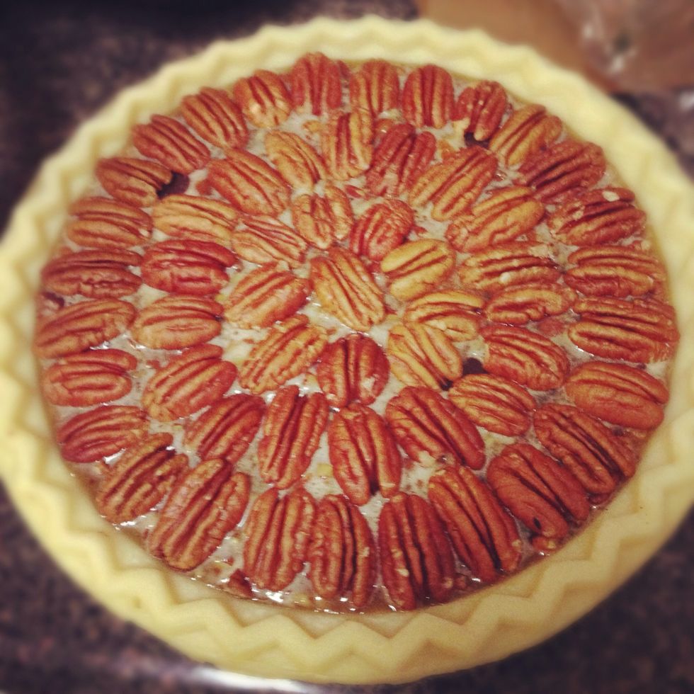 Pour in the mixture and arrange pecan halves in a circle starting with the outermost circle. Tip: save smaller pecans for use in the center.
