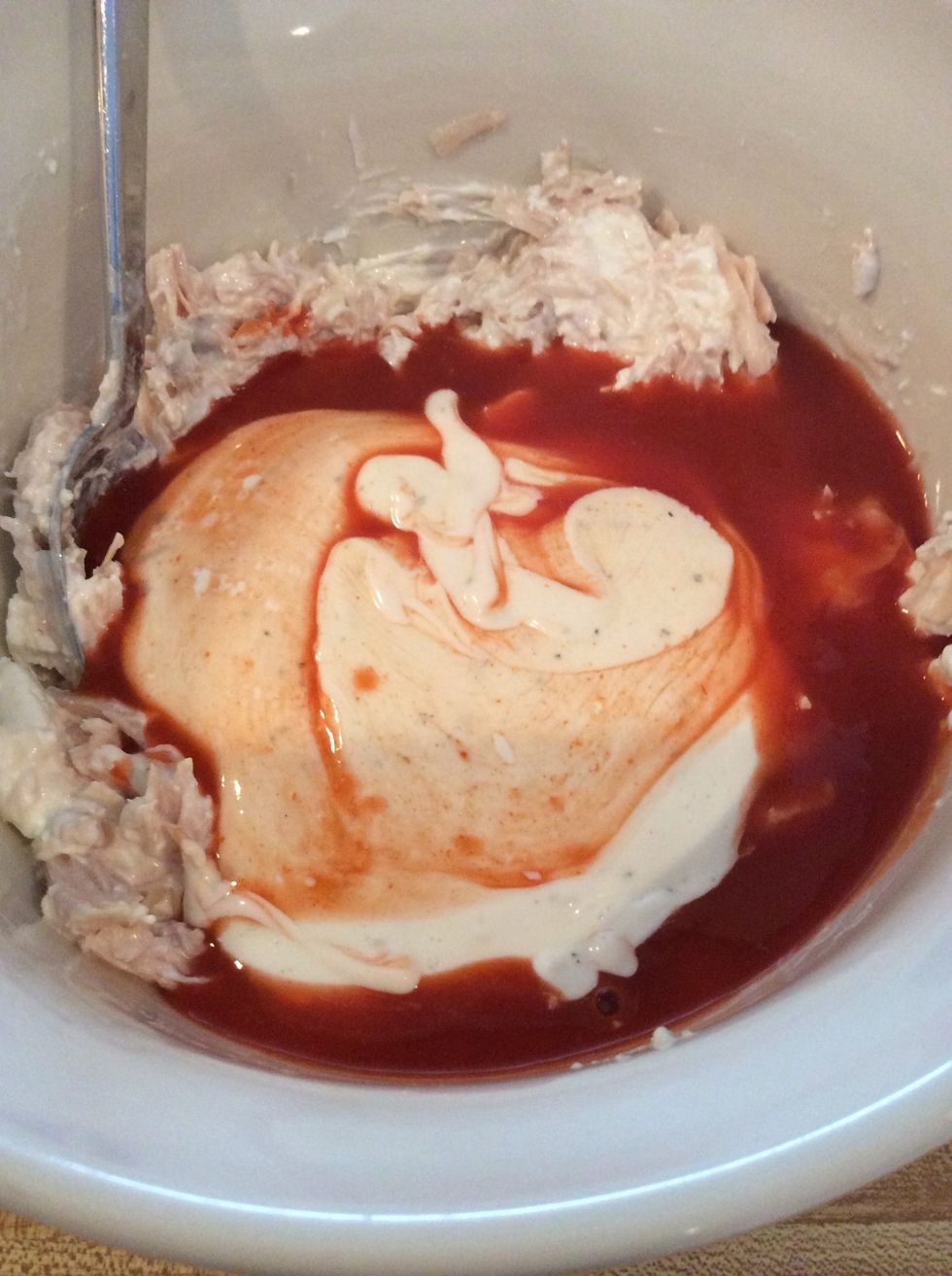 Pour in the Ranch dressing and Frank's Hot Sauce. If you luv spicy heat add a little extra hot sauce:)