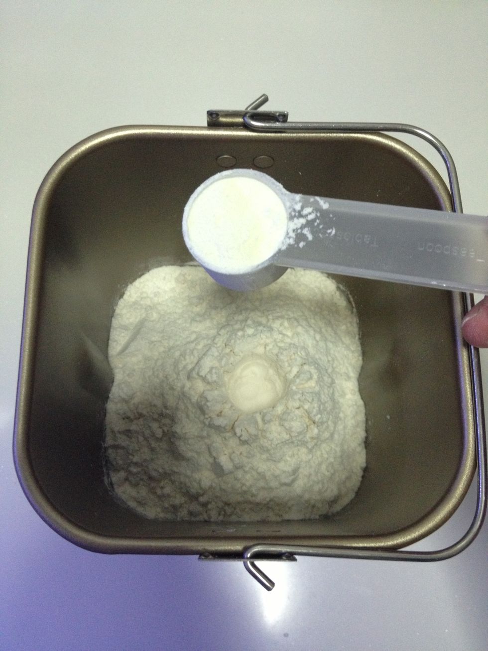 Pour in the skimmed milk powder.