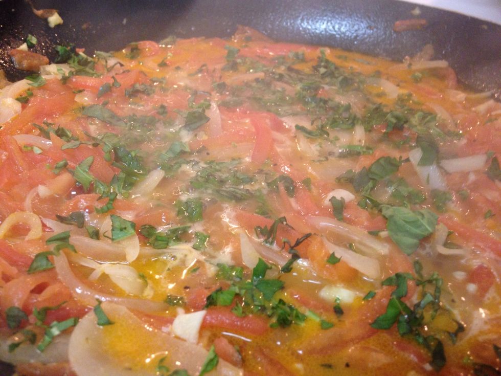 Pour in the stock, and bring to a simmer. When it comes to a simmer, this is when you will add your whole butter and the white wine. Continue to stir the sauce, and add your chopped basil.