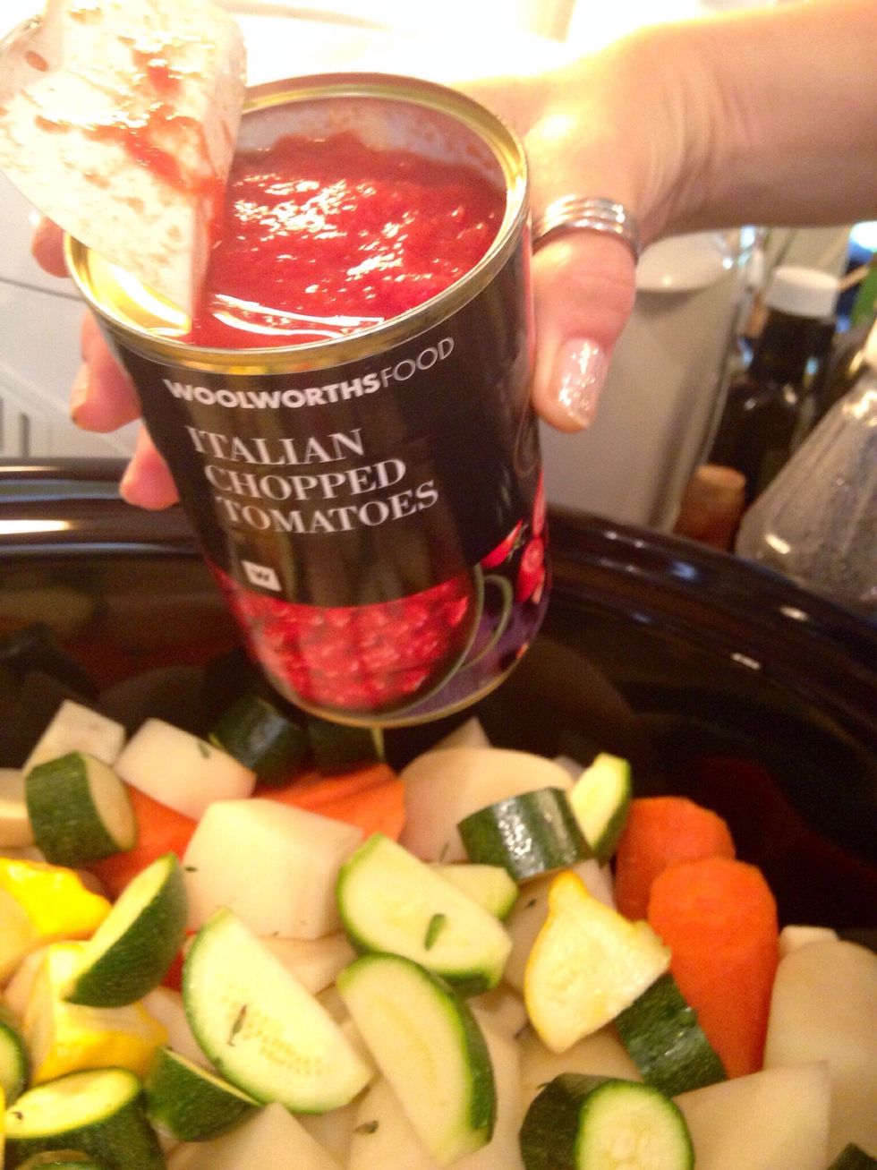 Pour in your favorite brand of tinned tomatoes. You can of course add fresh chopped tomatoes.