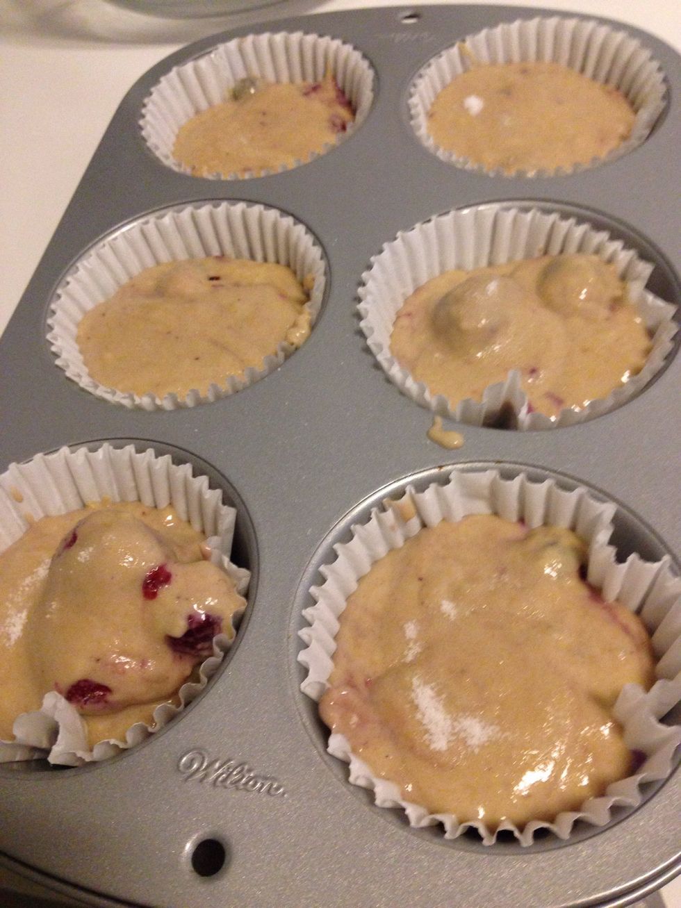 Pour into lined jumbo muffin tin, sprinkle tops with sugar, and bake for 30-40 minutes or until golden brown.