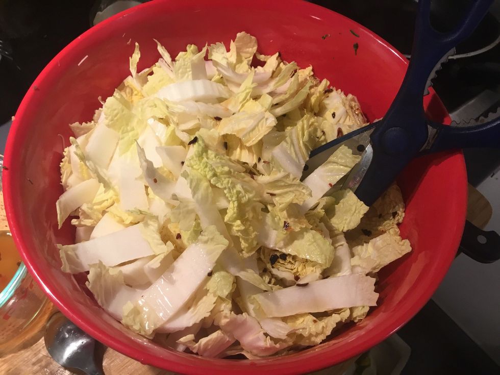 Pour into salad bowl and mix with scissors. Stir whilst cutting to shorten the noodles.