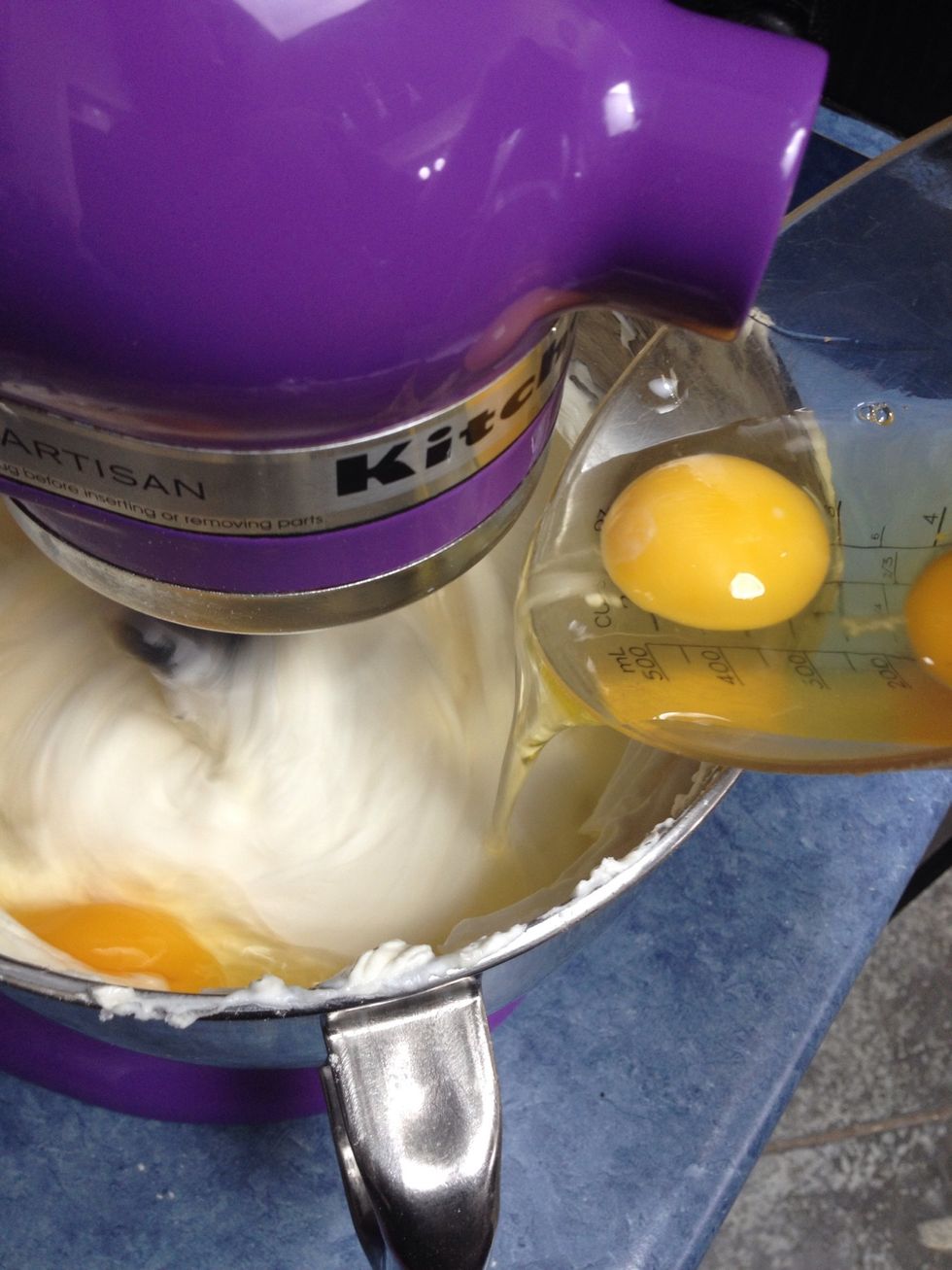 Pour into the batter while it's mixing at LOW speed.