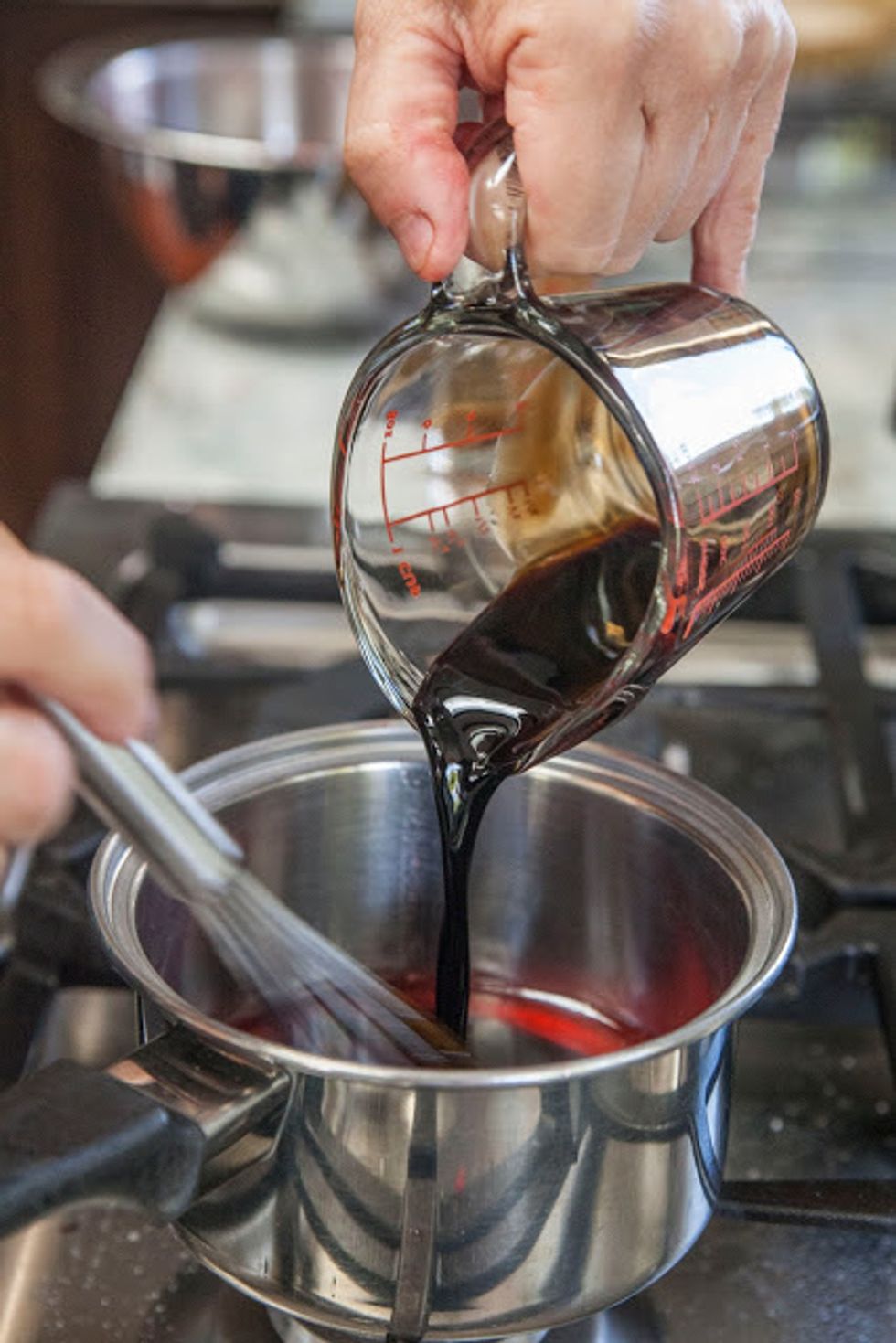 Pour it in and stir it around. Bring this mixture to a boil then turn it down to a simmer and simmer away until it's reduced. This takes about 15 minutes or so