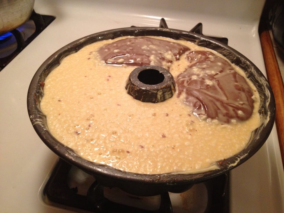 Pour it SLOWLY on top of the batter...wait a couple of minutes for some of it to sink...the rest will do it while in the oven :)