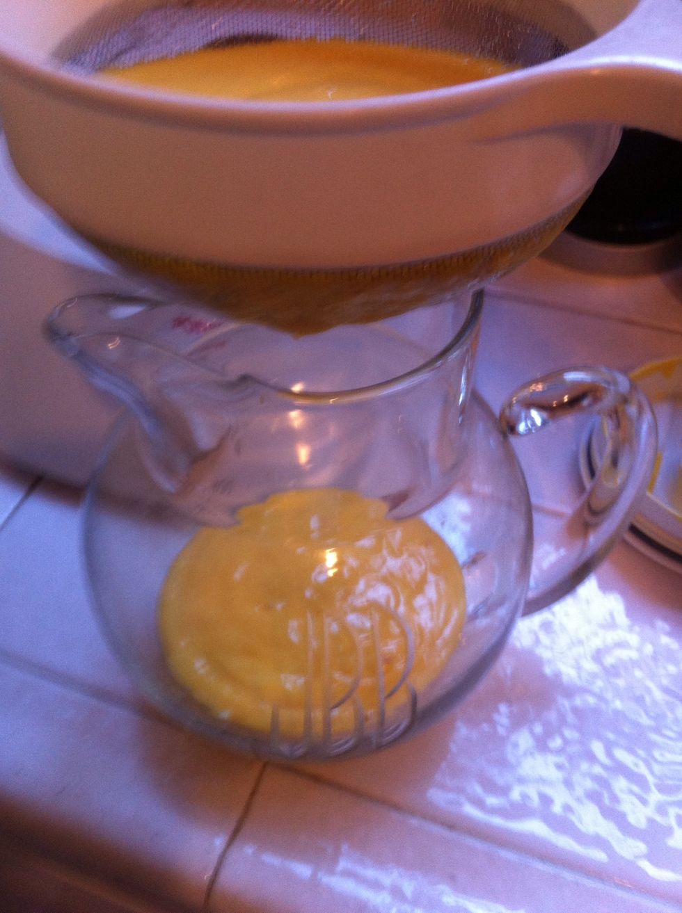 pour it through a fine mesh strainer, to keep those weird bits of mango string and whatever else clogging my strainer. it goes very slow. be patient (or use your fingers to help it through like I did)