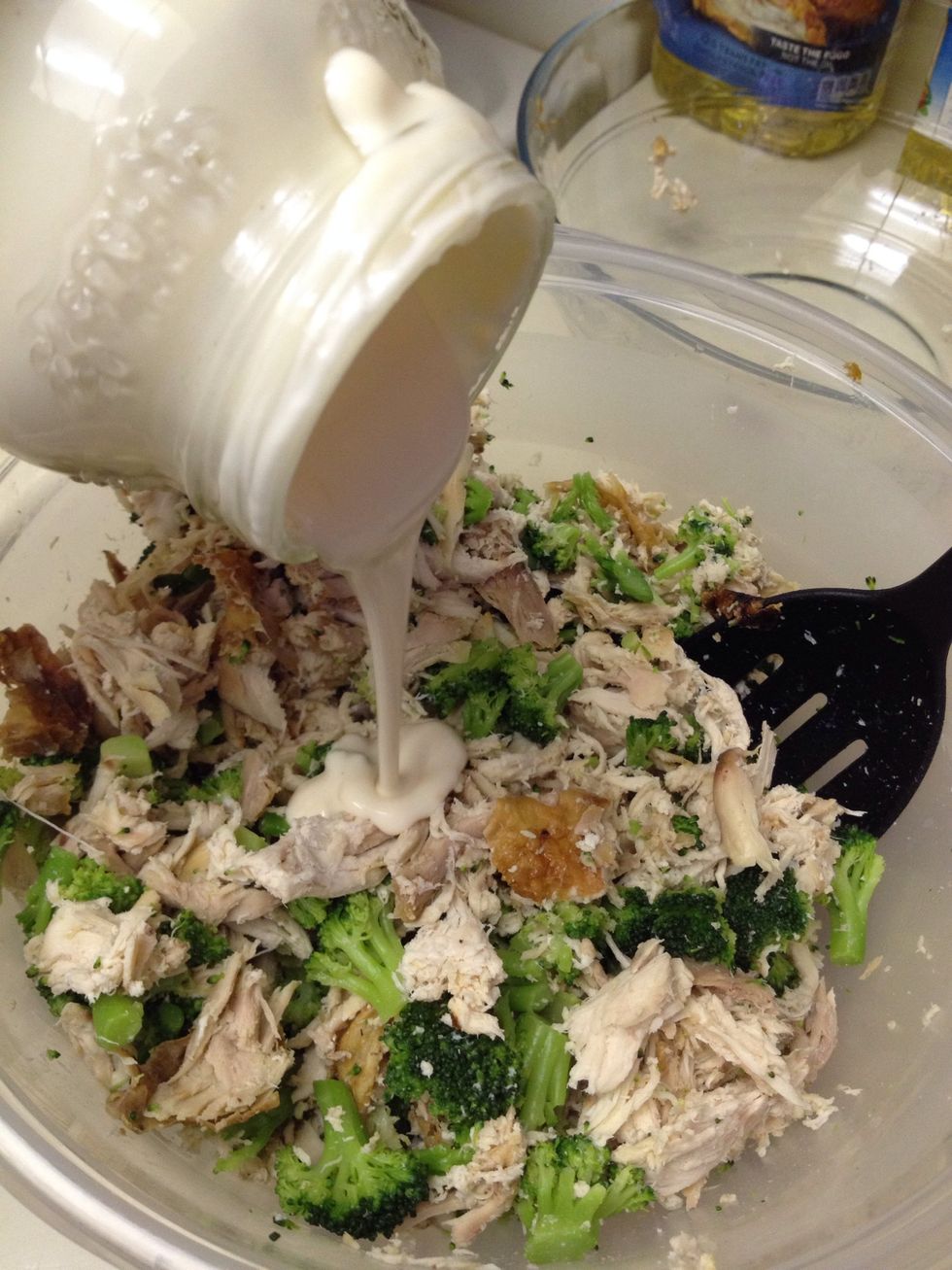 Pour jar of Alfredo sauce into mixture.