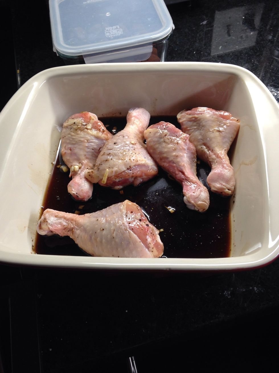 Pour marinade over drumsticks, cover with plastic wrap.