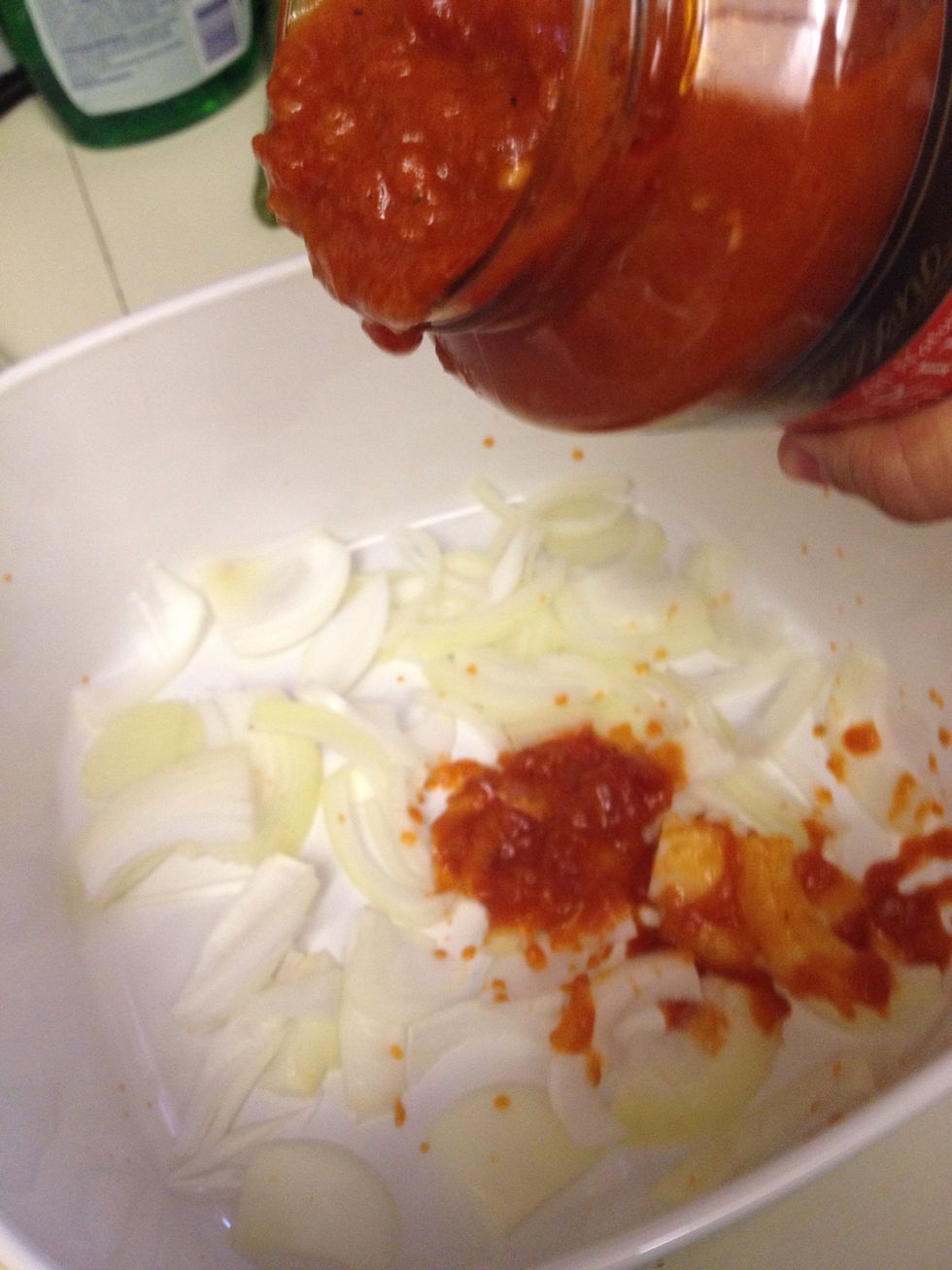 Pour marinara over your first onion layer.