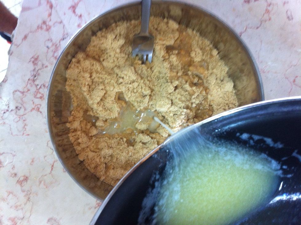 Pour melted butter on the bisquits and mix