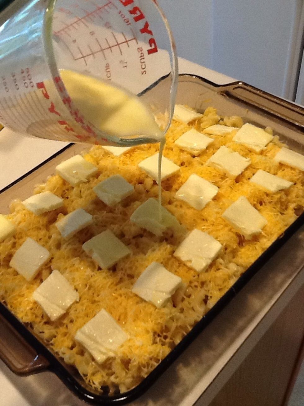 Pour milk and egg mixture evenly on top of the macaroni and cheese.