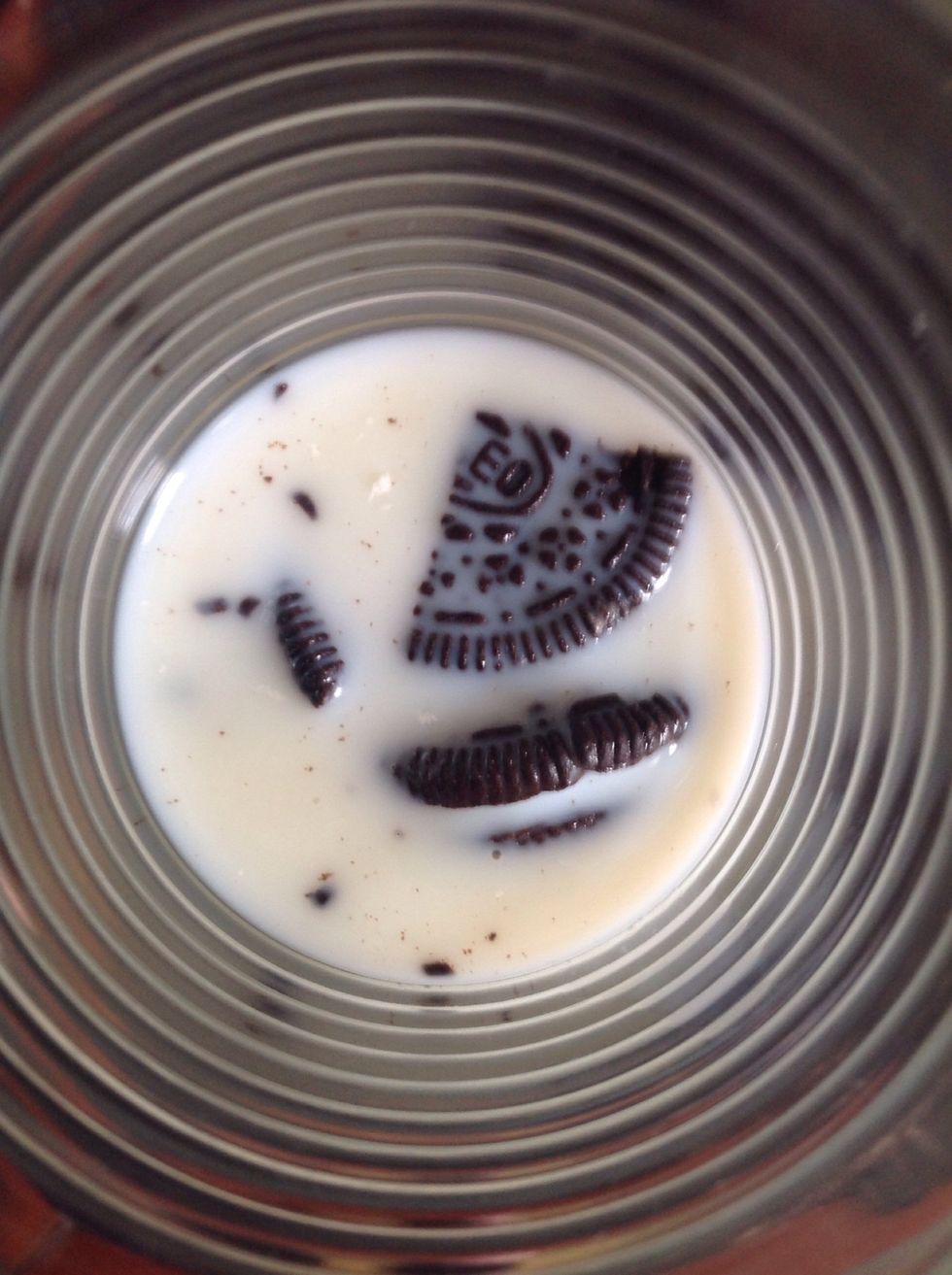 Pour milk in the glass until almost all of the Oreos are covered.