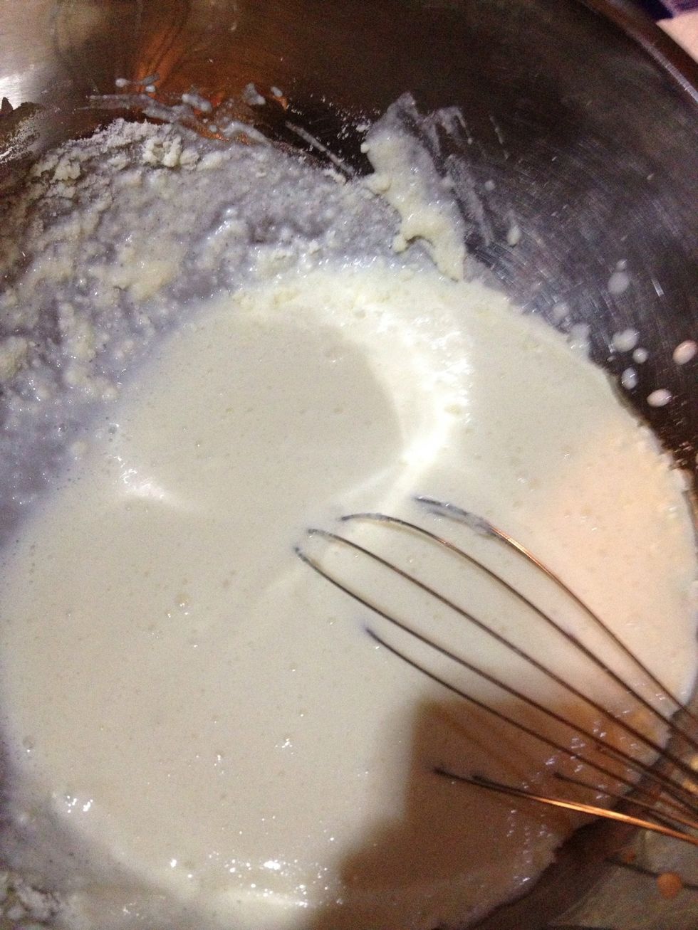 Pour milk into the cheese mix and whisk together