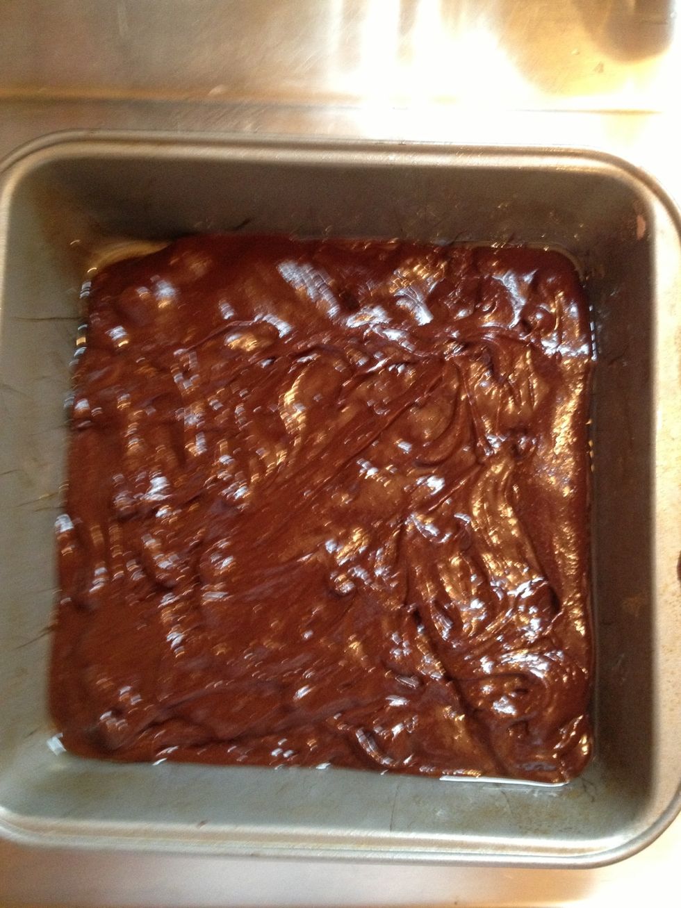 Pour mix into 8 by 8 greased pan. Put into oven and cook for 20 to 25 minutes.  Remove from oven and let cool.