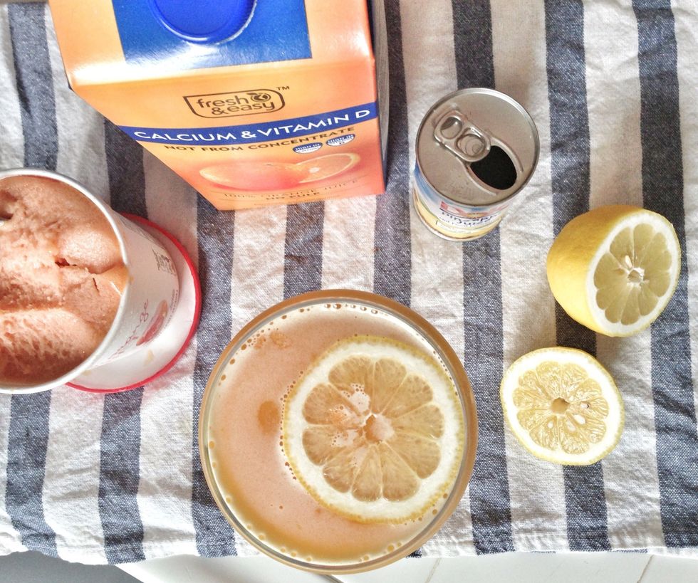 Pour mixed mocktail into champagne goblet, garnish with a thin slice of lemon, and enjoy!
