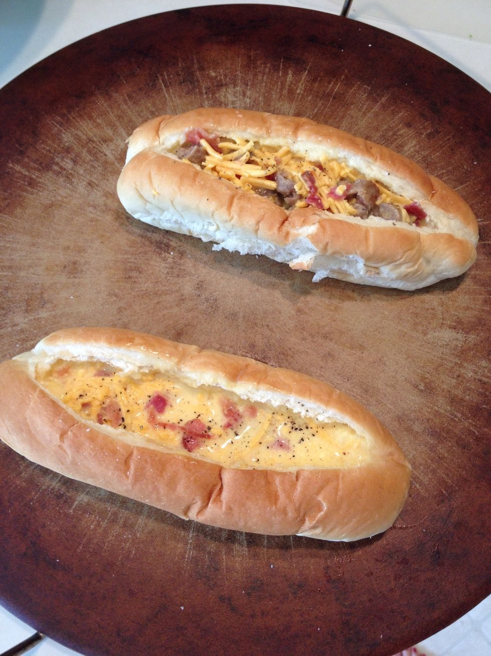 Pour mixture in bread boats. I made one with just bacon, egg, and cheese for my son and a different one for my daughter. (Note: the less ingredients you use, the longer you may need to bake.)