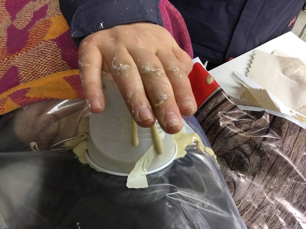 Pour mixture into a cup on top of friend and hold there