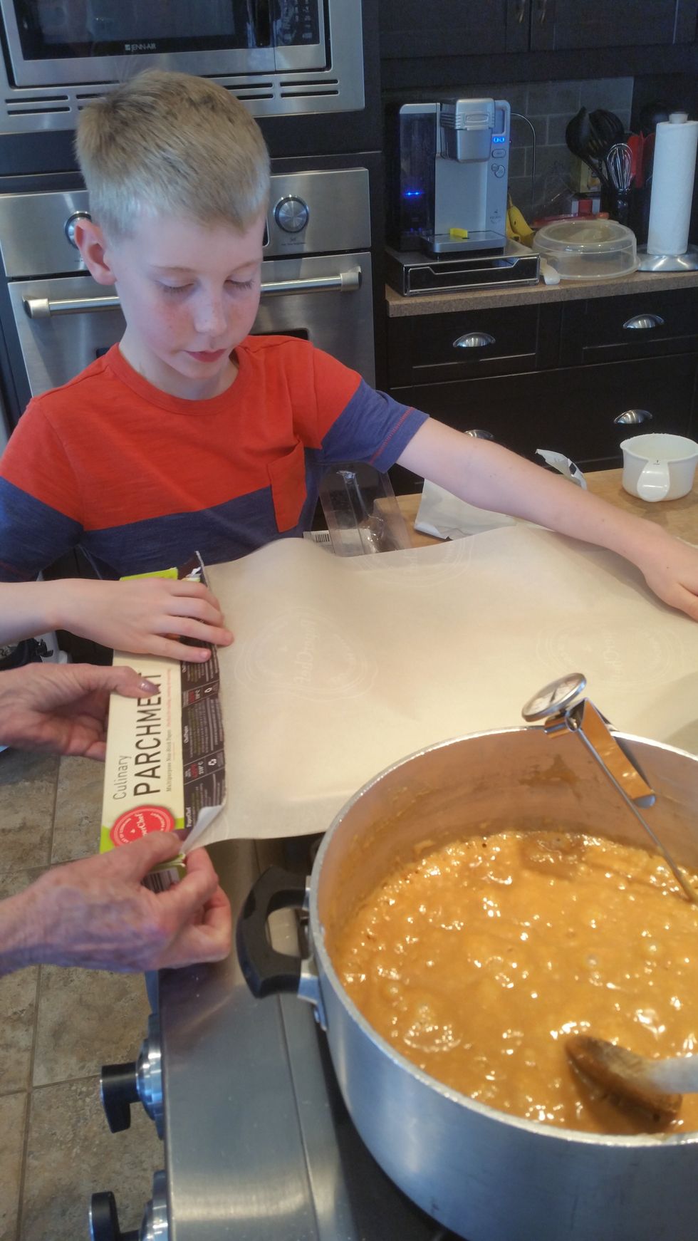 Pour mixture on a cookie sheet lined with parchment paper. Have adult do this, it is very hot!