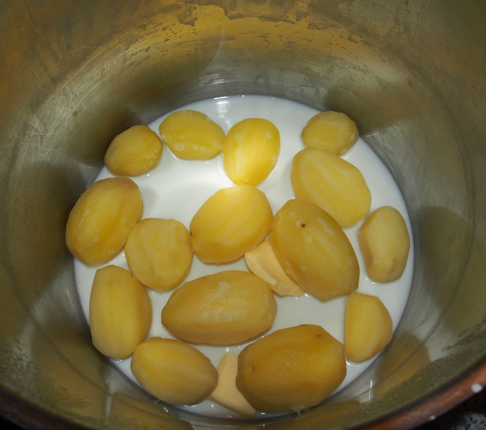 Pour off the water and add butter to the potatoes.