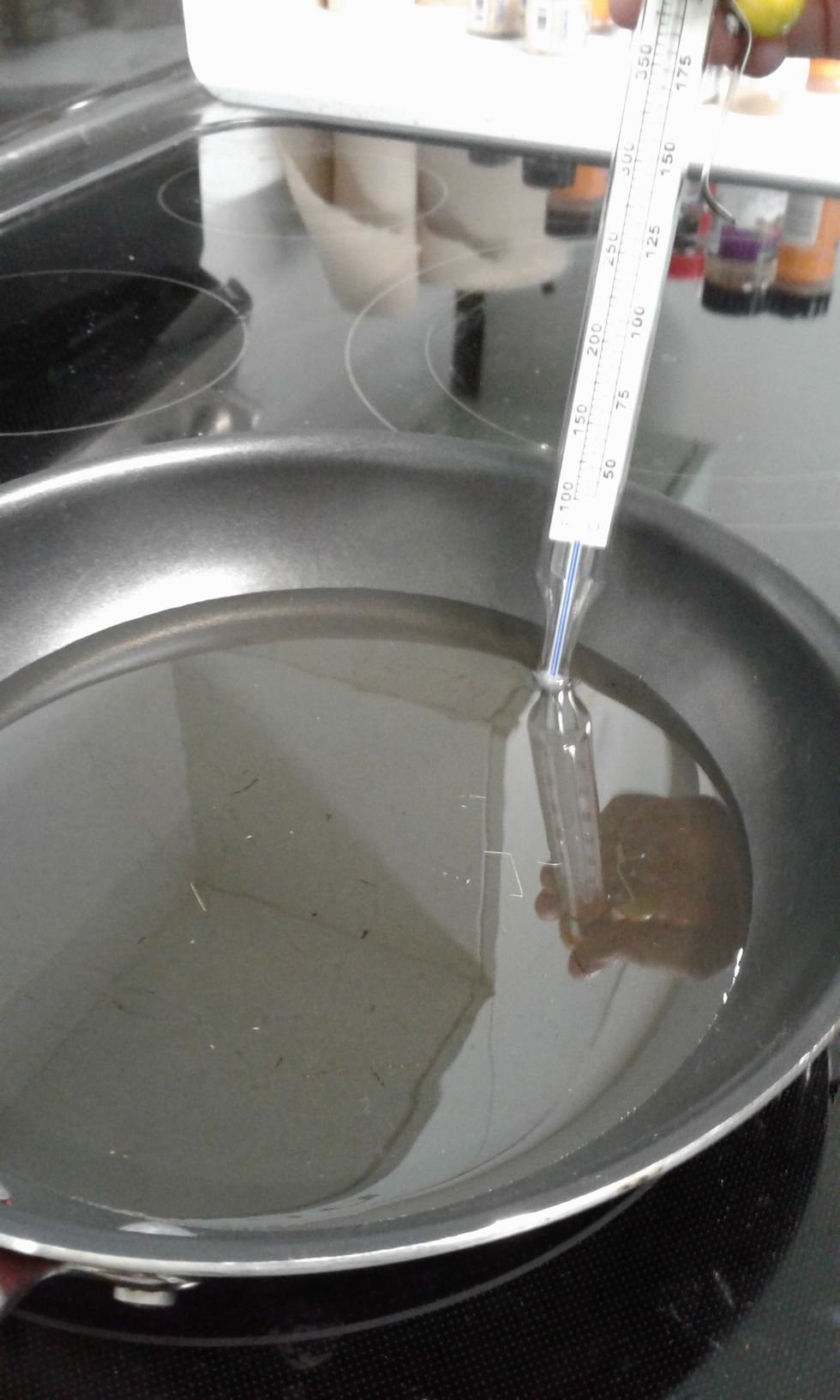 pour oil in to a cast iron skillet to a depth of 3/4. prop deep fry thermometer in oil so bulb is submerged. heat over medium/high heat until thermometer registers 350 degrees