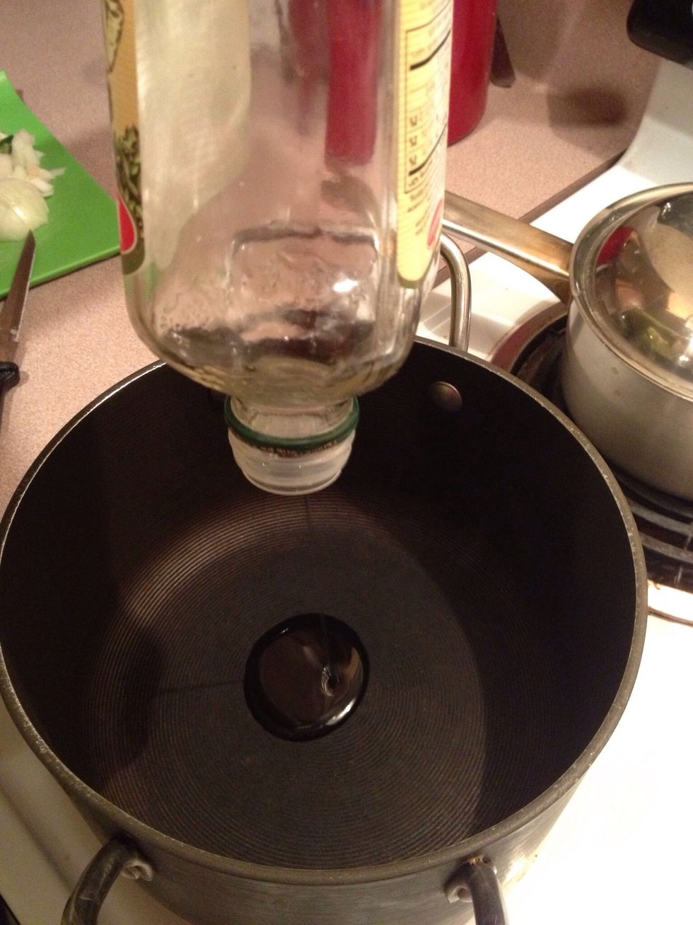 Pour olive oil into pan.