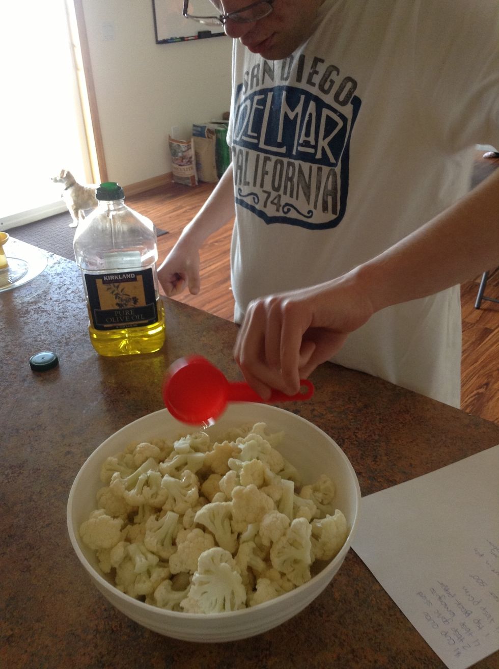 Pour olive oil over cauliflower