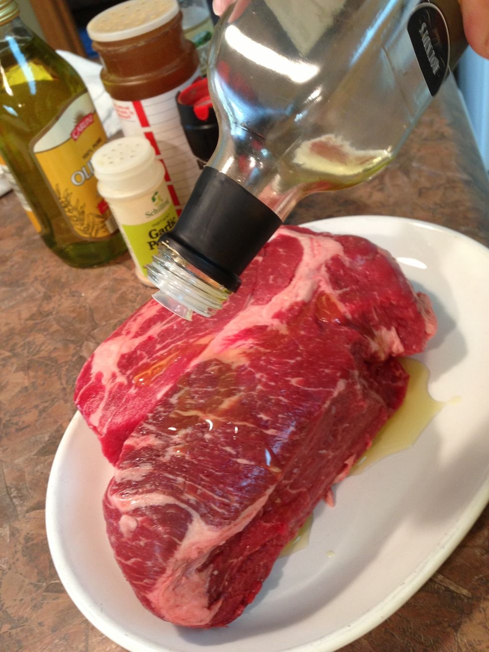 Pour olive oil over meat and spread over entire surface with clean hands. (Never work with raw meat on a wooden or porous surface where bacteria can be trapped.)
