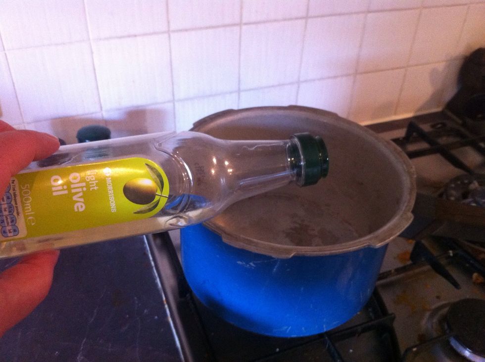 Pour olive or vegetable oil into base of pot (around 2 tablespoons)