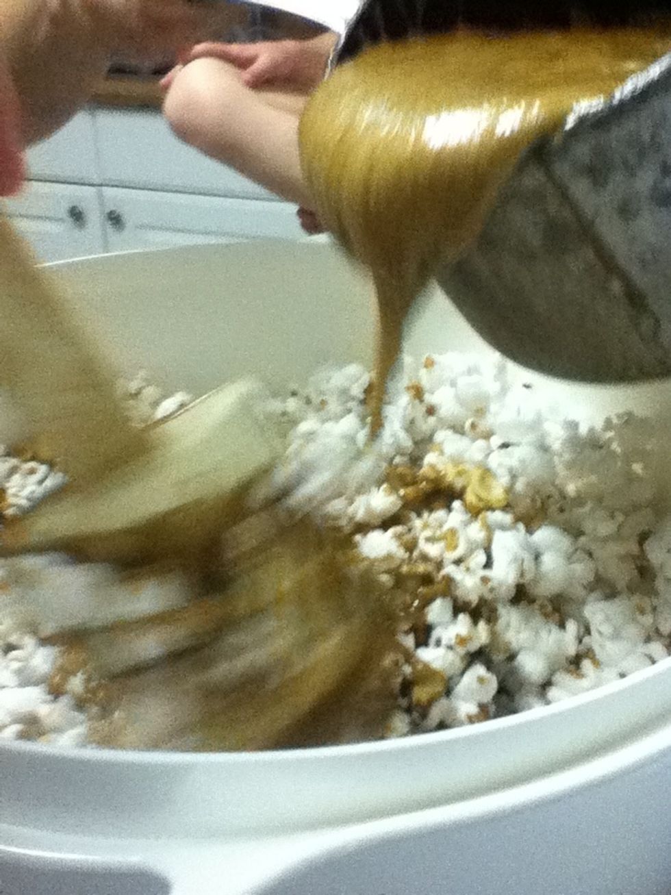 Pour on popcorn and stir rapidly for about 10 minutes