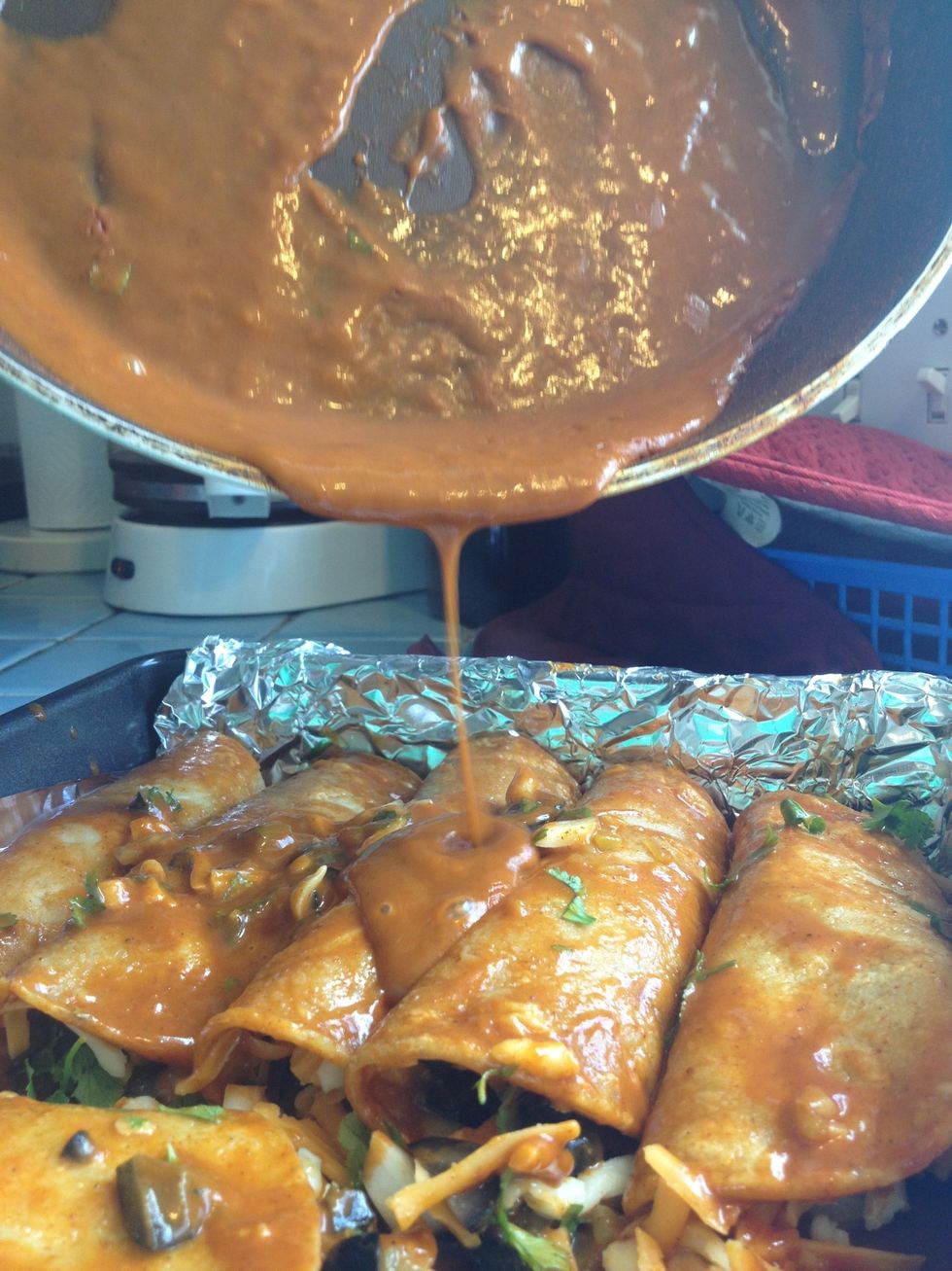 Pour on the remaining enchilada sauce and spread evenly over the enchiladas..