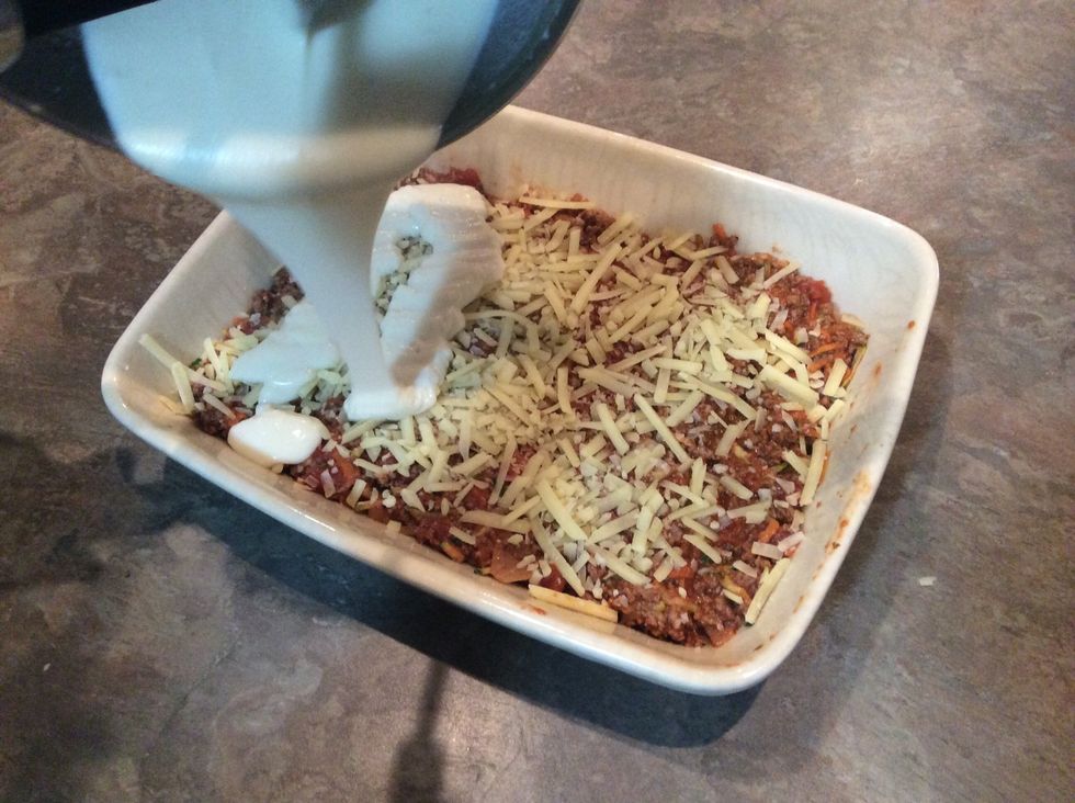 Pour on white sauce mixture from saucepan.