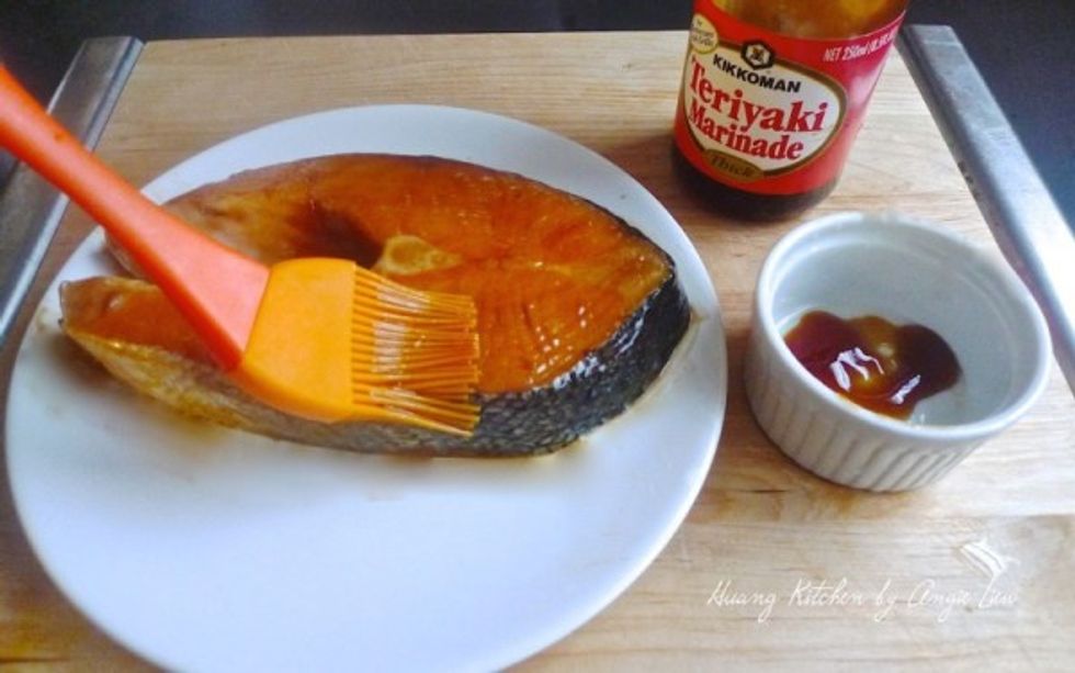 Pour or brush the teriyaki marinade evenly over the salmon fillet.