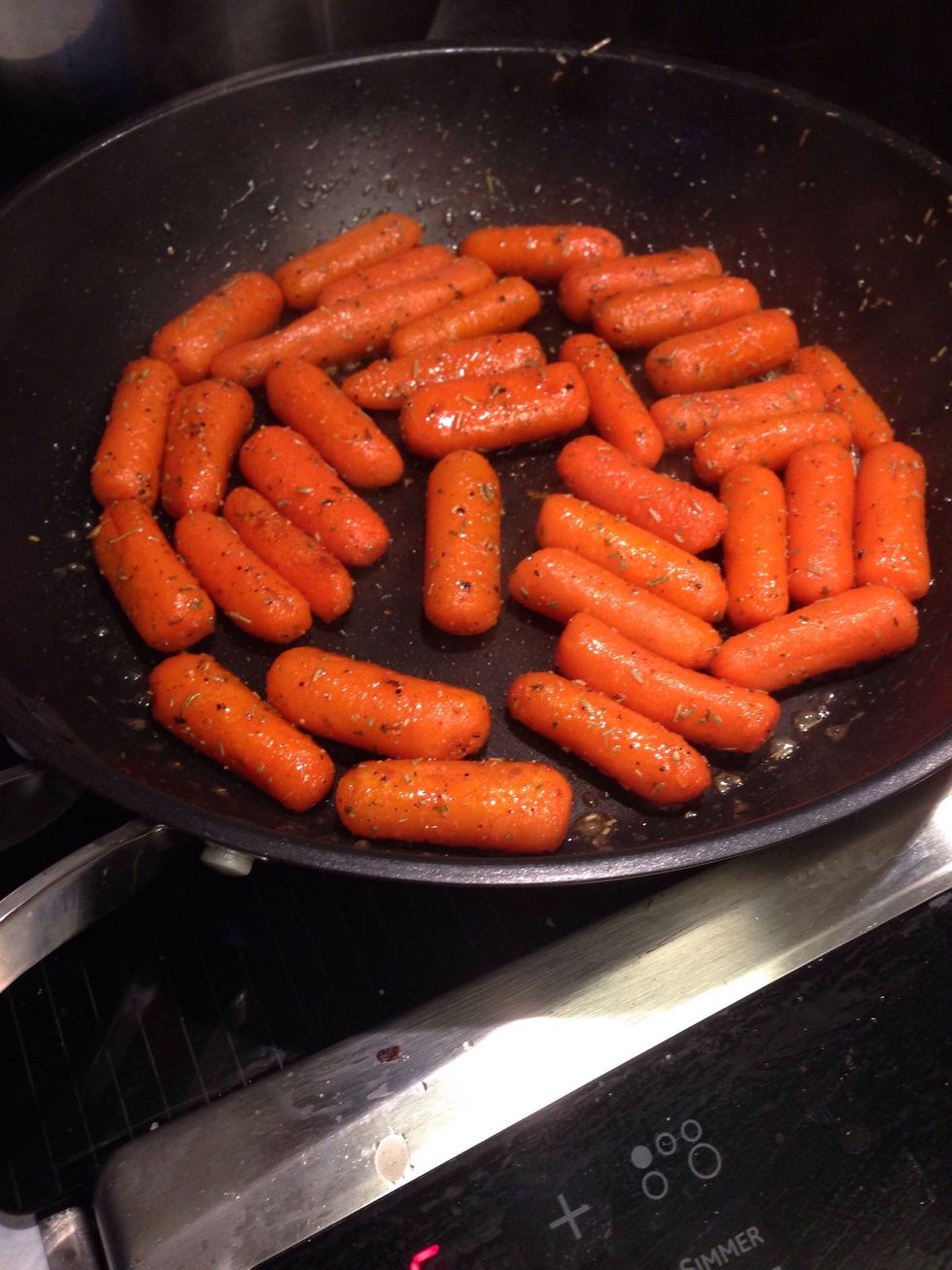 Pour over carrots in a frying pan on high heat. Cook for 4 minutes flipping every minute