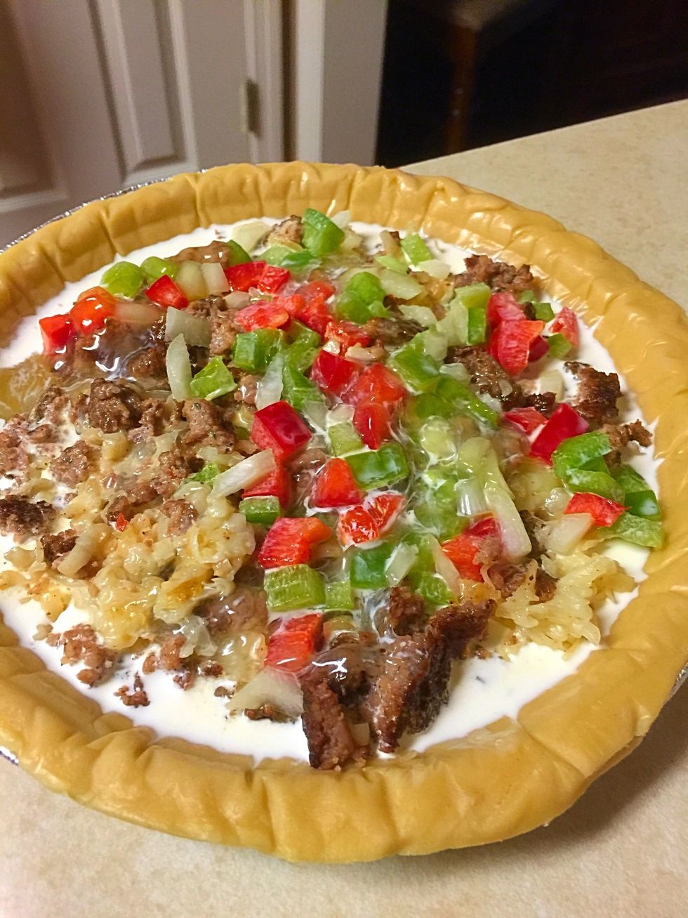 Pour over sausage and cheese mixture in pie shell.