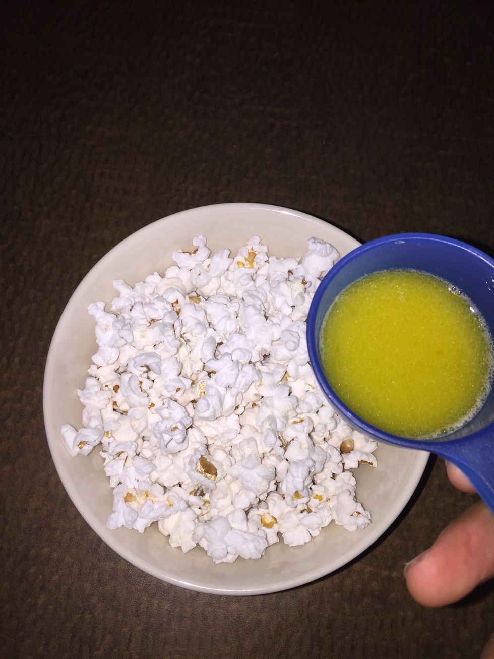 Pour over your popcorn and try to evenly distribute it