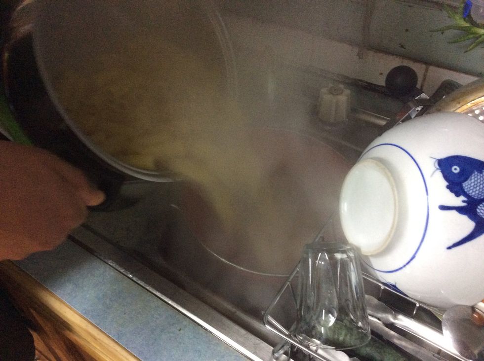 Pour pasta into colander