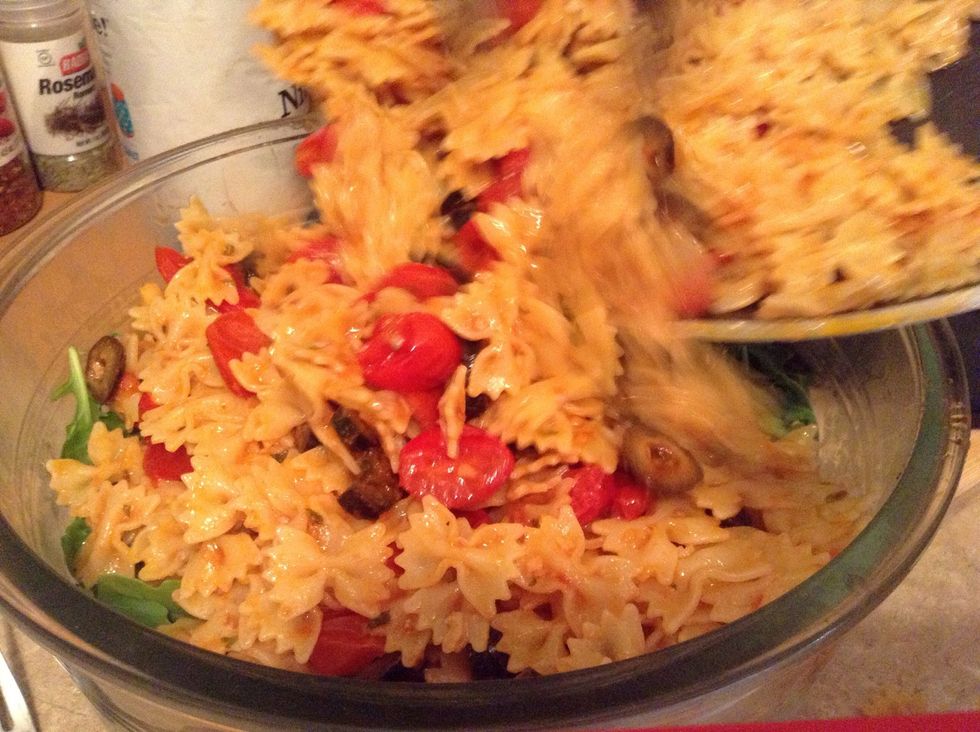 Pour pasta mixture into salad bowl (you could alternatively pour salad mixture into pan to melt the mozzarella more; it all comes down to preference)