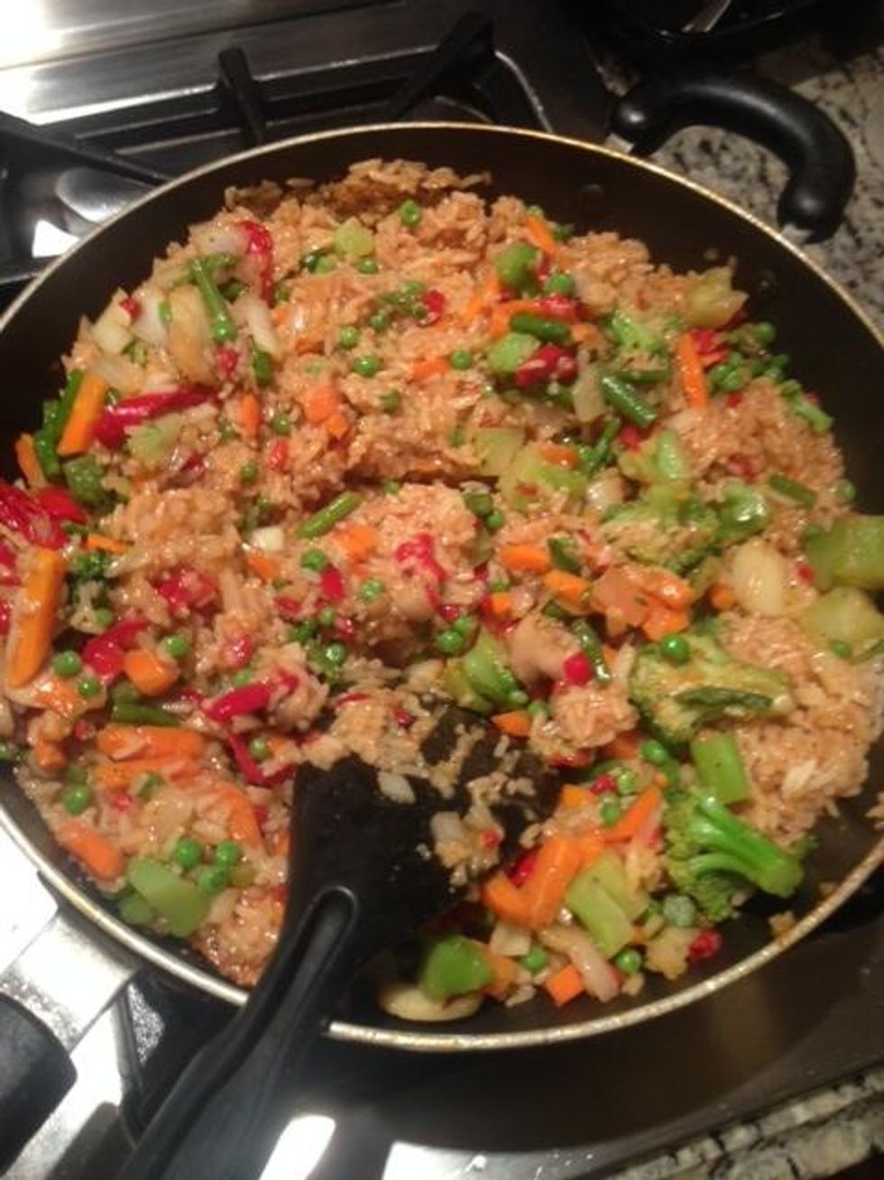 Pour rice in first and let it cook for about 2 minutes. Then add all other ingredients. Add scrambled eggs.Add garlic butter and soy sauce. Mix on medium heat until rice has made a brown color.