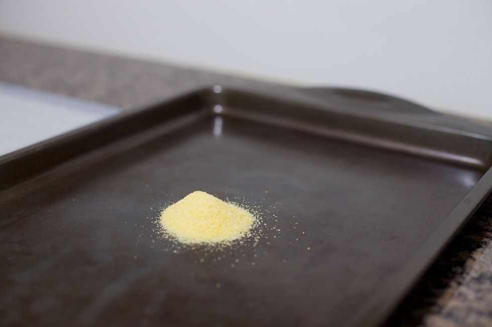Pour some cornmeal out onto a large cookie sheet.  You'll be dipping the bottom of the rolls in this to prevent it from sticking to the cookie sheet.  It also makes the crust crispier.