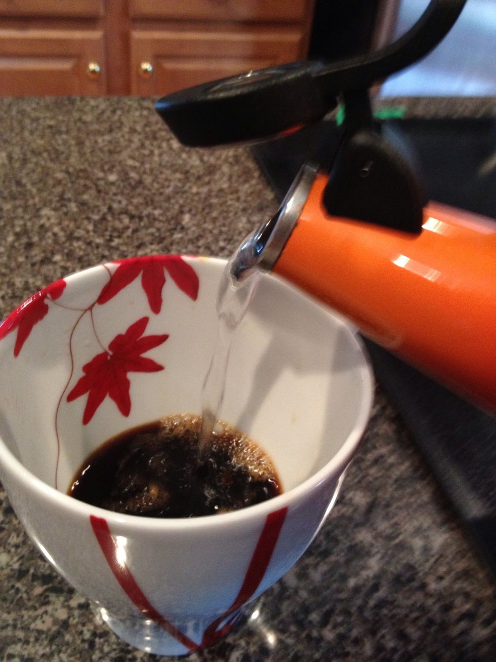 Pour some of the remaining hot water into your mug. Measure out 6 - 8 oz with a measuring cup if you don't know what it should look like in your mug yet. The less water the stronger the cup will be.