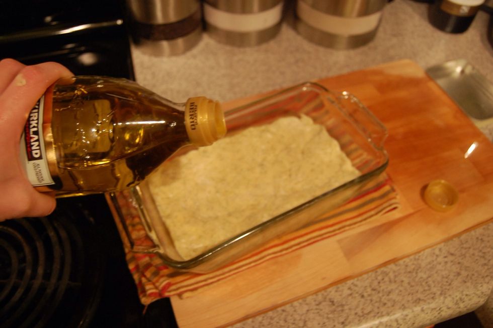 Pour some olive oil on top of dough and brush it over the top of the loaf. I just use my fingers.