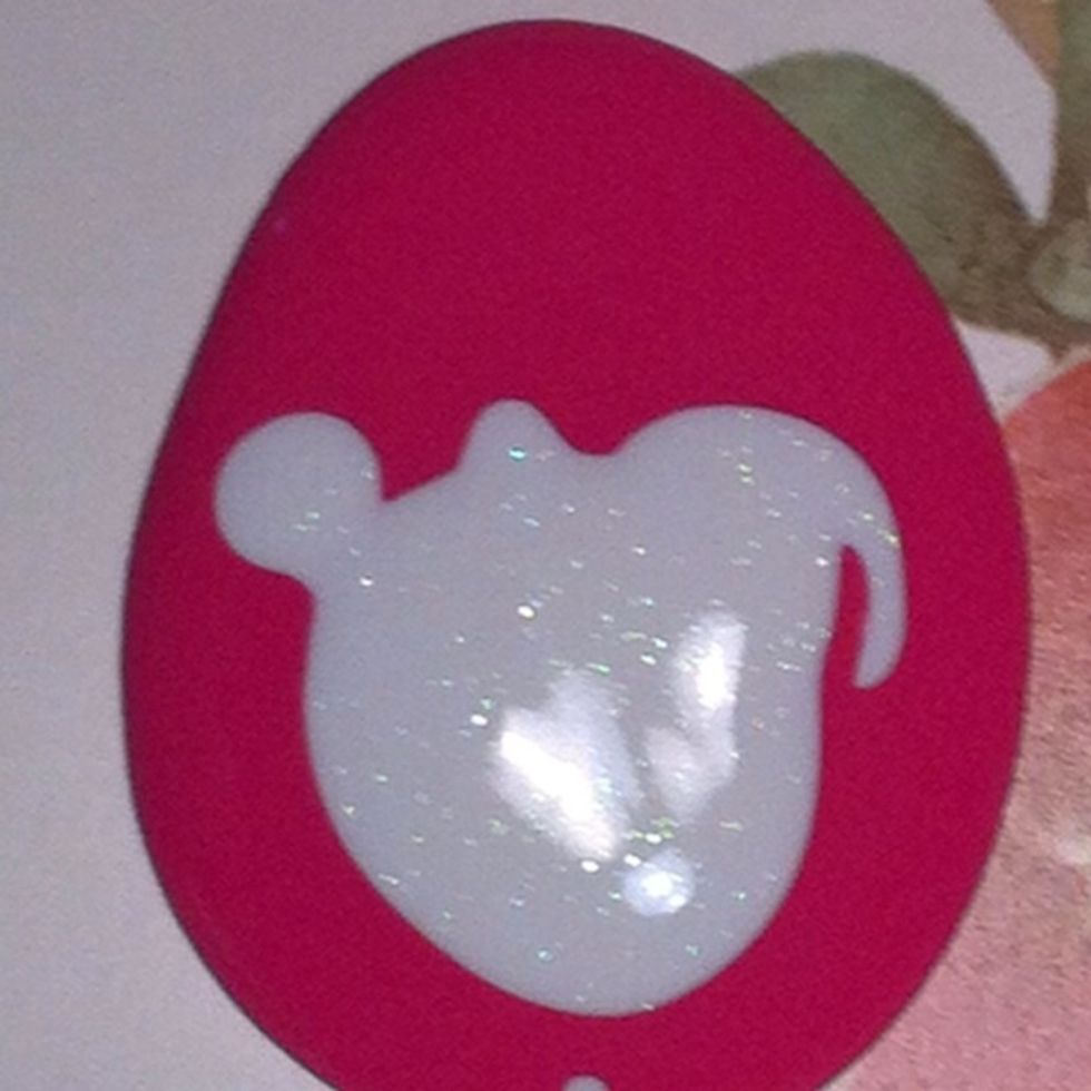 Pour some paint and some glitter onto a paper plate. You need a puddle to work with, not the entire bottle!