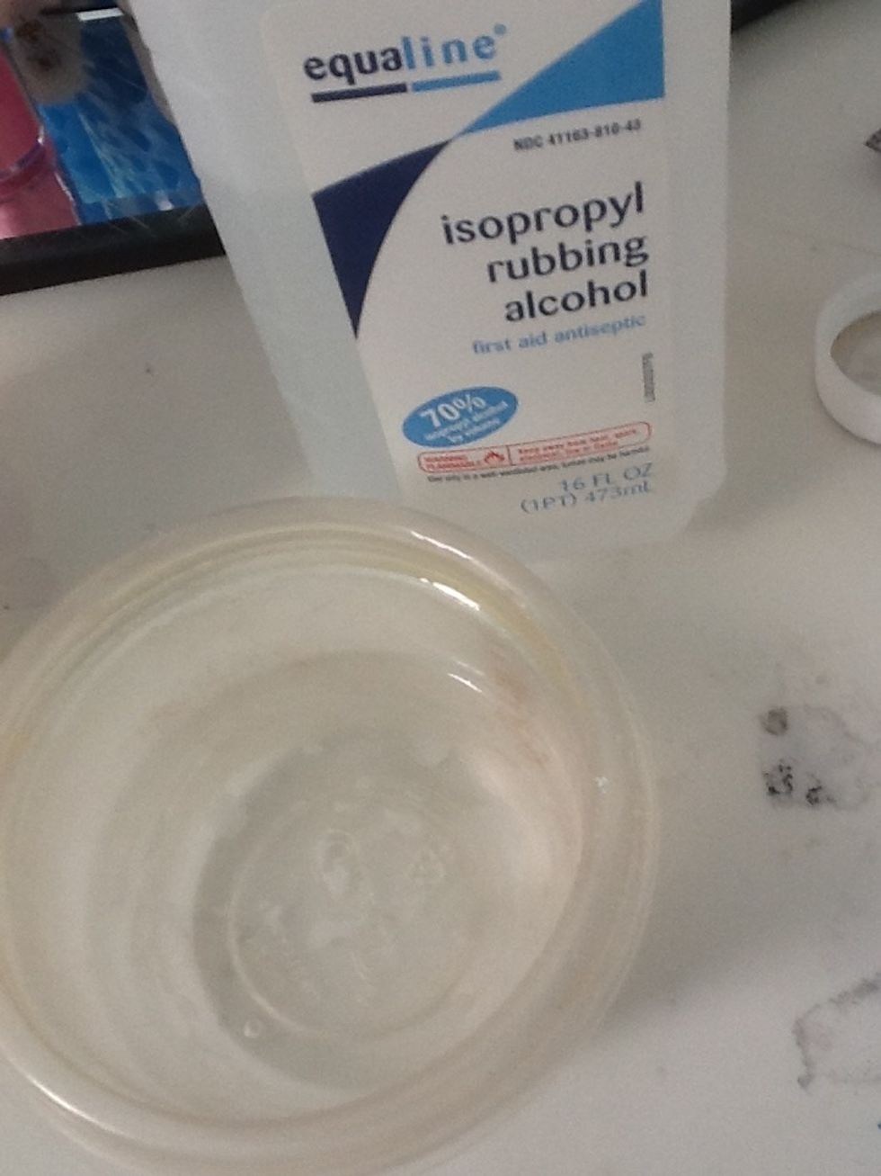Pour some rubbing alcohol in a small cup