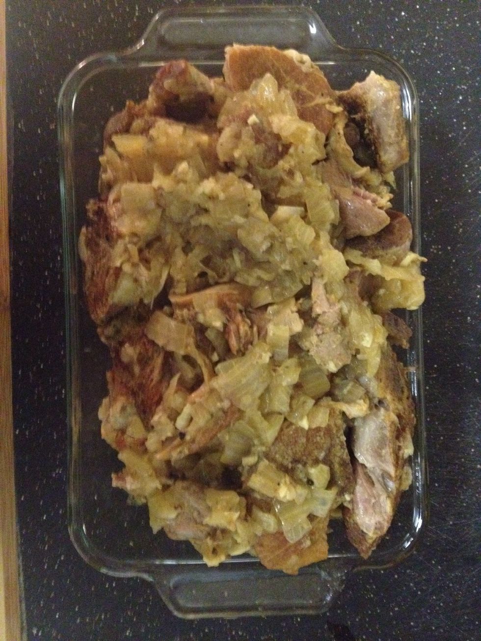 Pour strained onion and garlic from liquid over the meat.