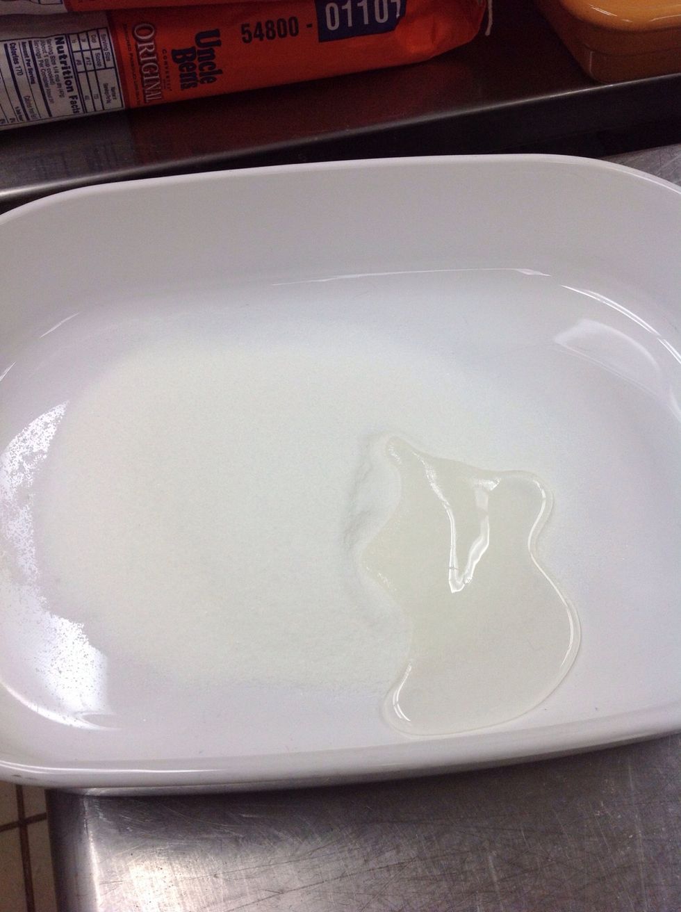 Pour sugar and corn syrup into baking dish.