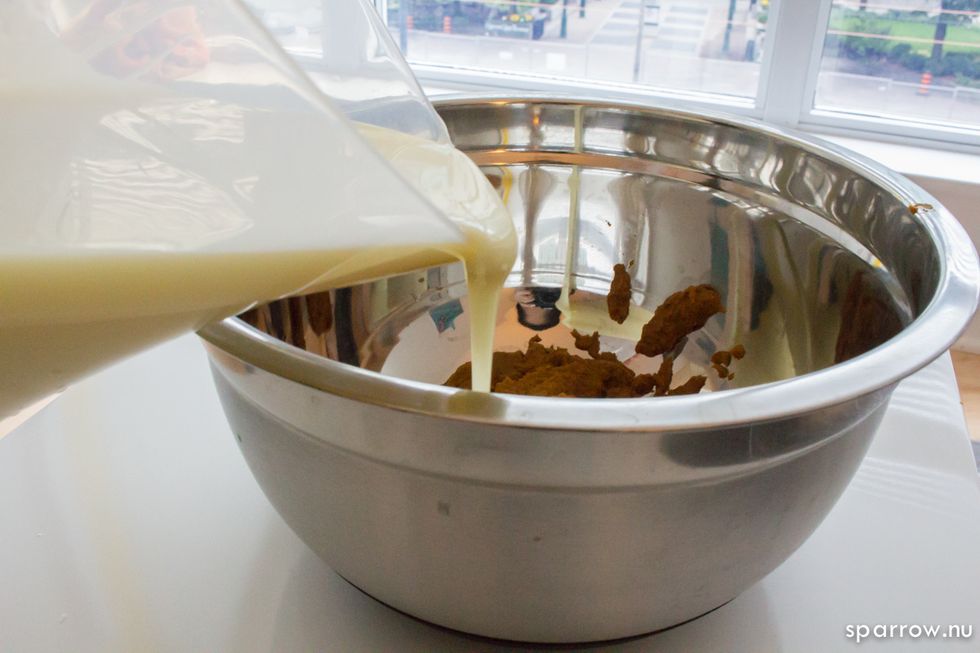 Pour sweet condensed milk into pumpkin puree mixture.